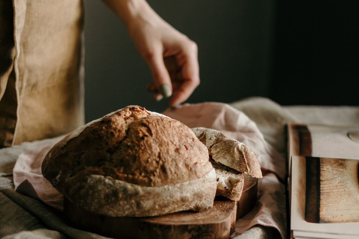 Person reintroducing a single trigger food like wheat bread while logging symptoms in a notebook