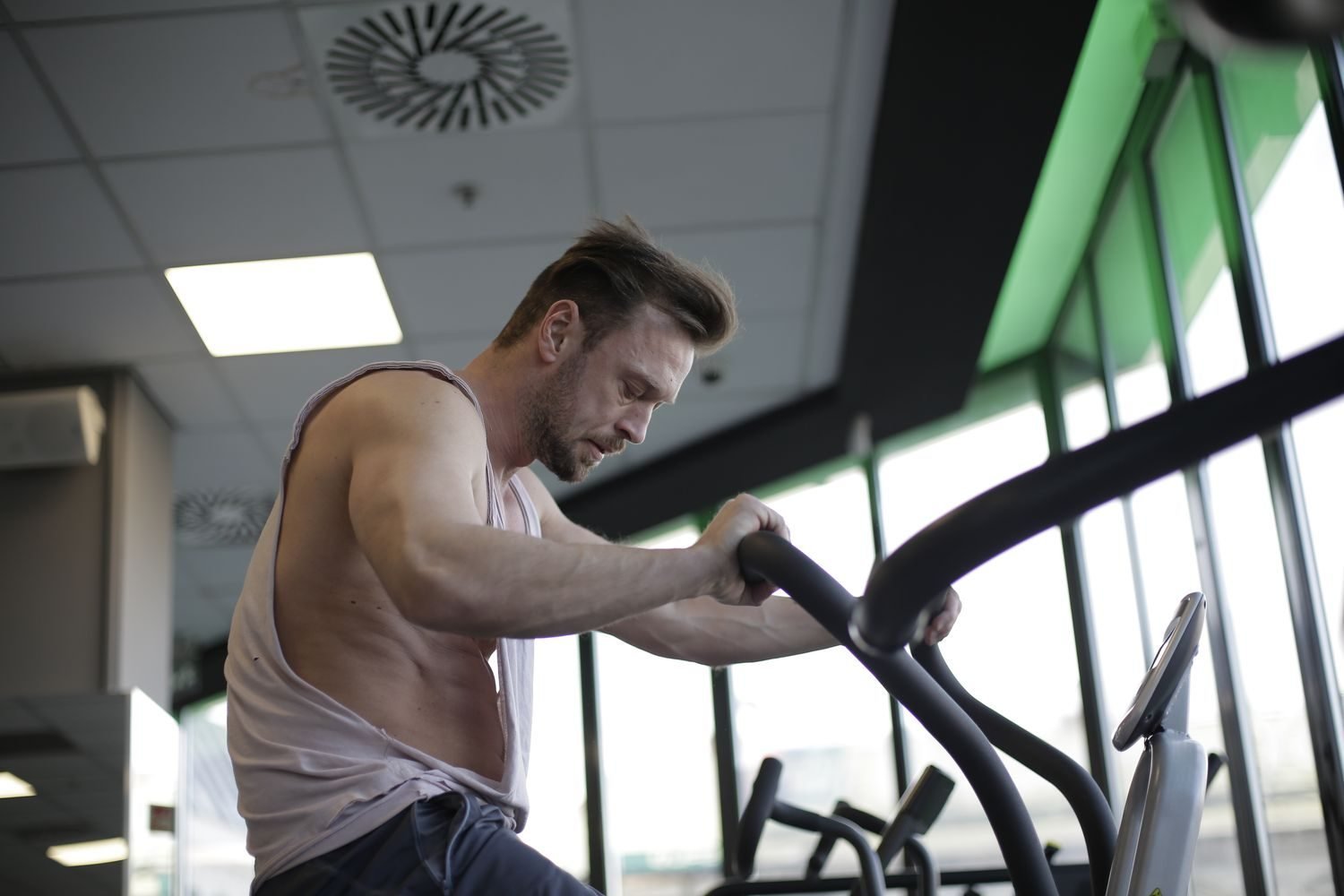 Man using an elliptical machine during a gym cardio session