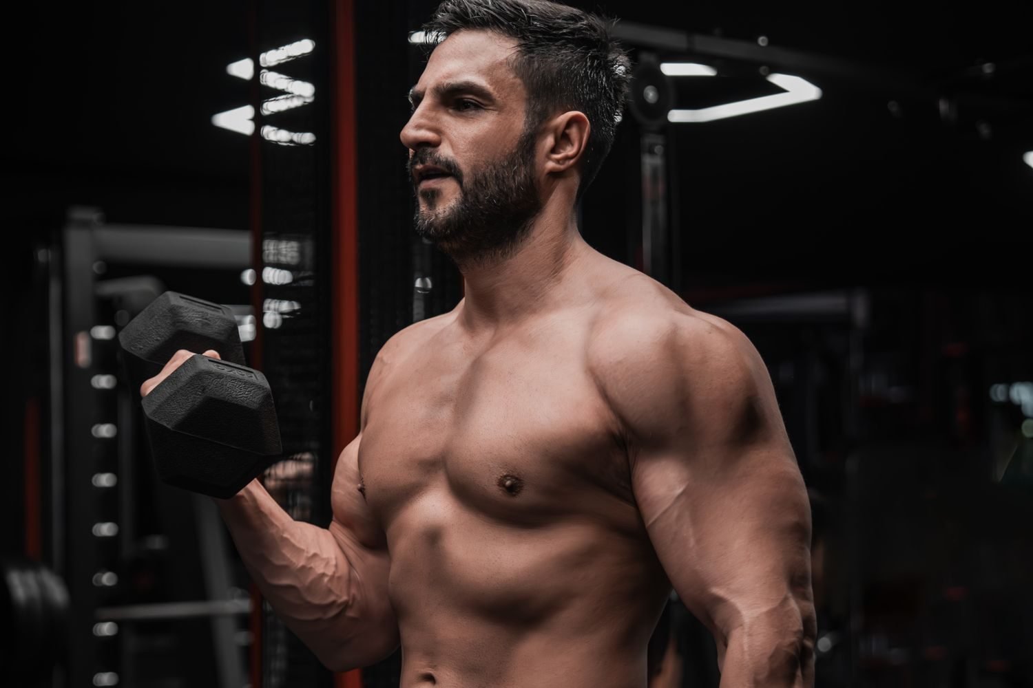Man performing a dumbbell bicep curl during a gym workout