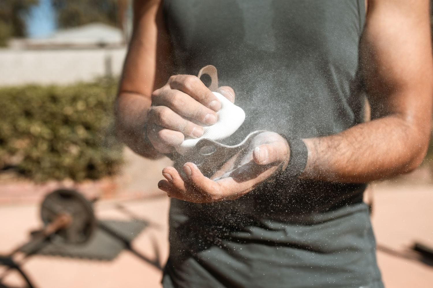 Man chalking his hands before a heavy barbell lift