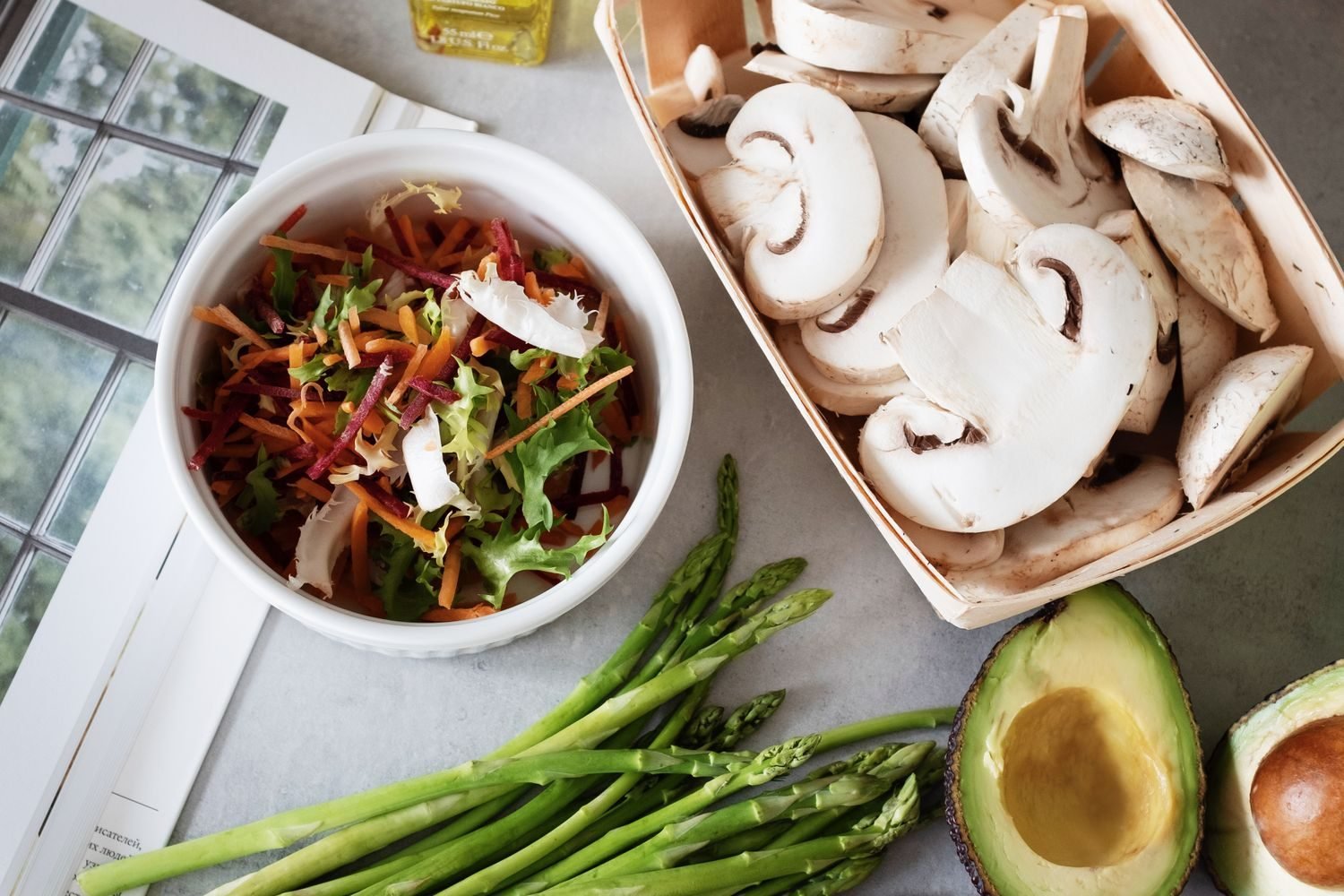 Fresh vegetables, olive oil, whole grains, and legumes arranged as ingredients for a liver-friendly meal plan