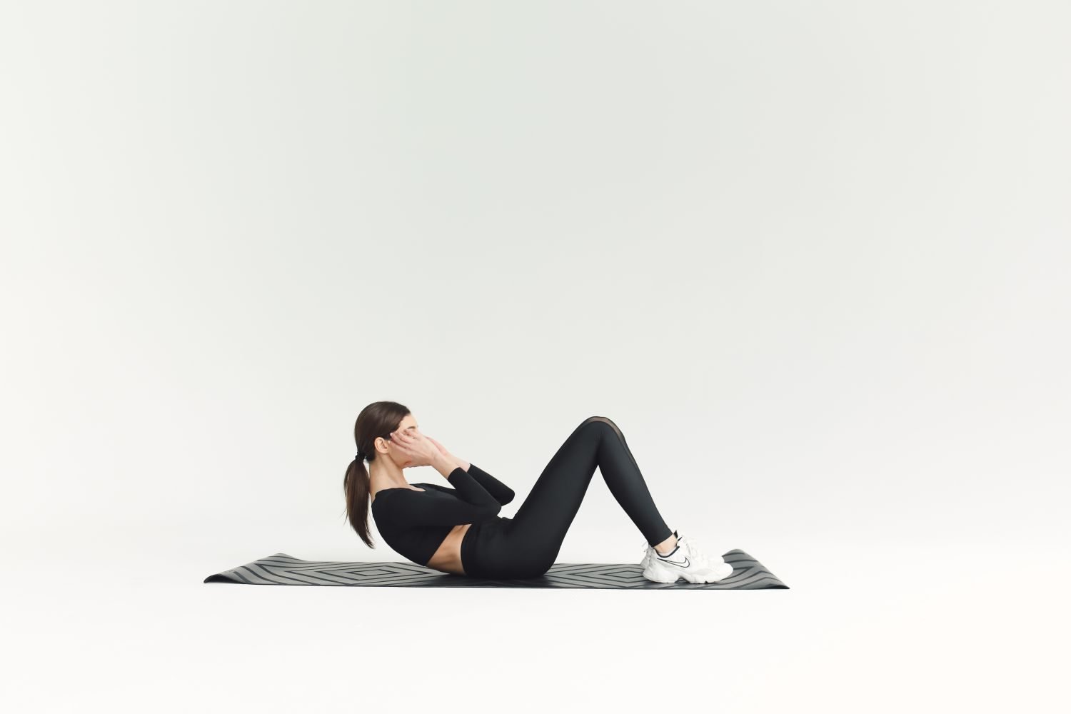 Woman performing a crunch exercise on a mat
