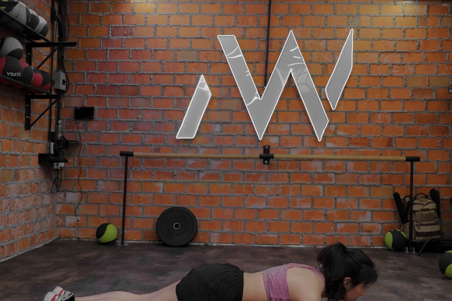 Woman holding a plank position on the gym floor