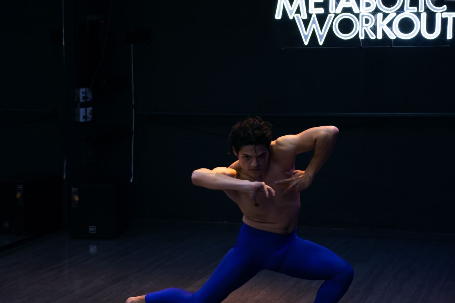 Person doing strength training with weights, representing muscle mass as a driver of resting metabolic rate