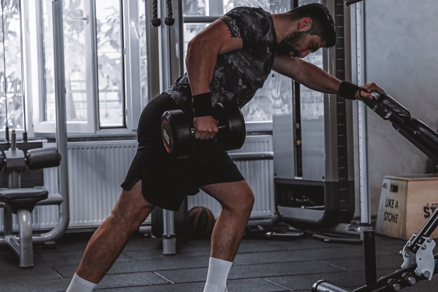 Man performing a dumbbell row at the gym