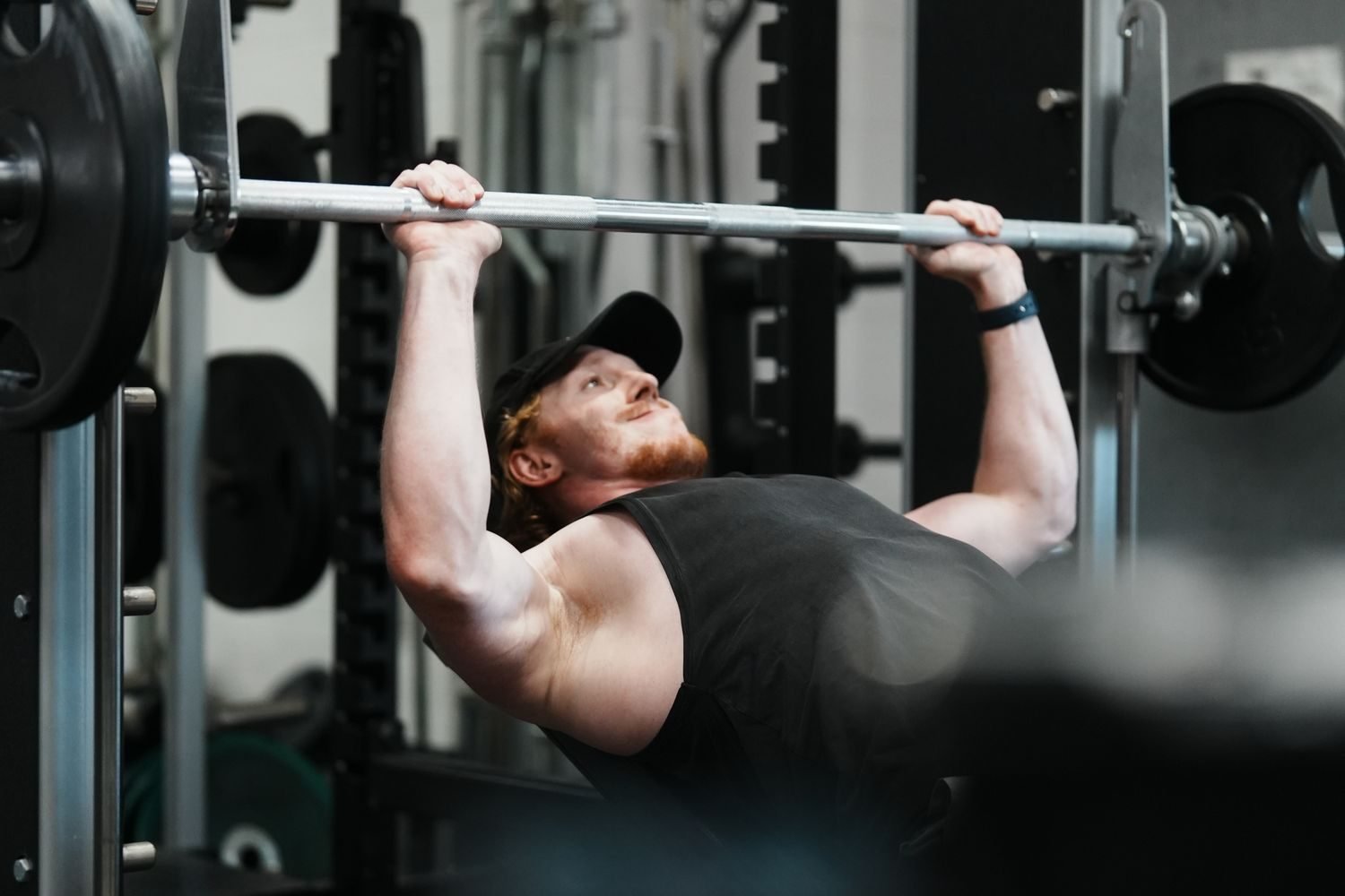 Man performing a close-grip bench press for triceps