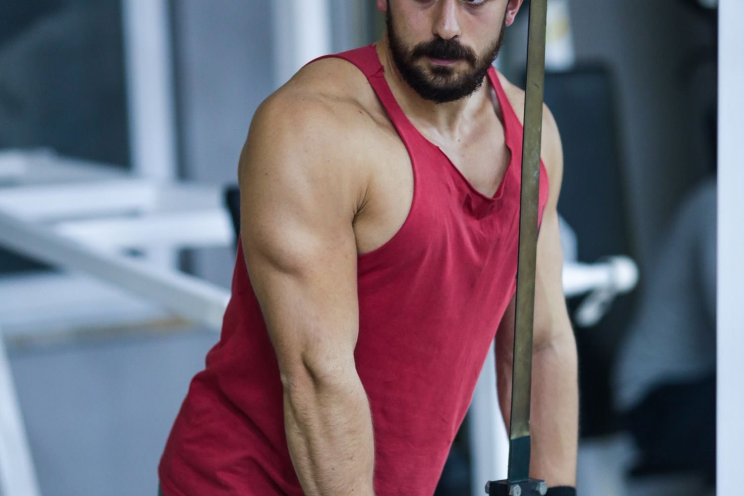 Man performing a cable tricep pushdown in the gym