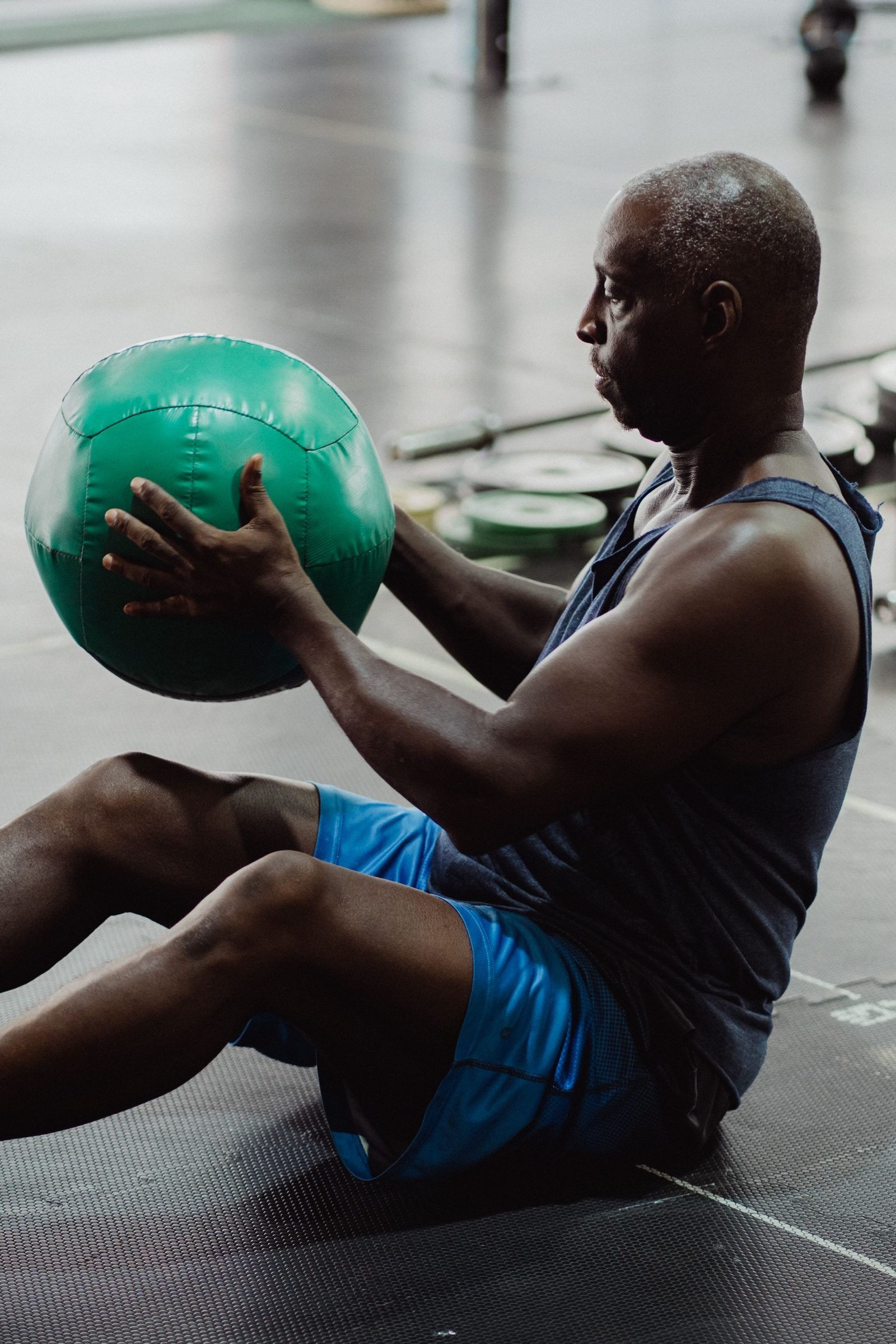 Man performing a seated medicine ball exercise