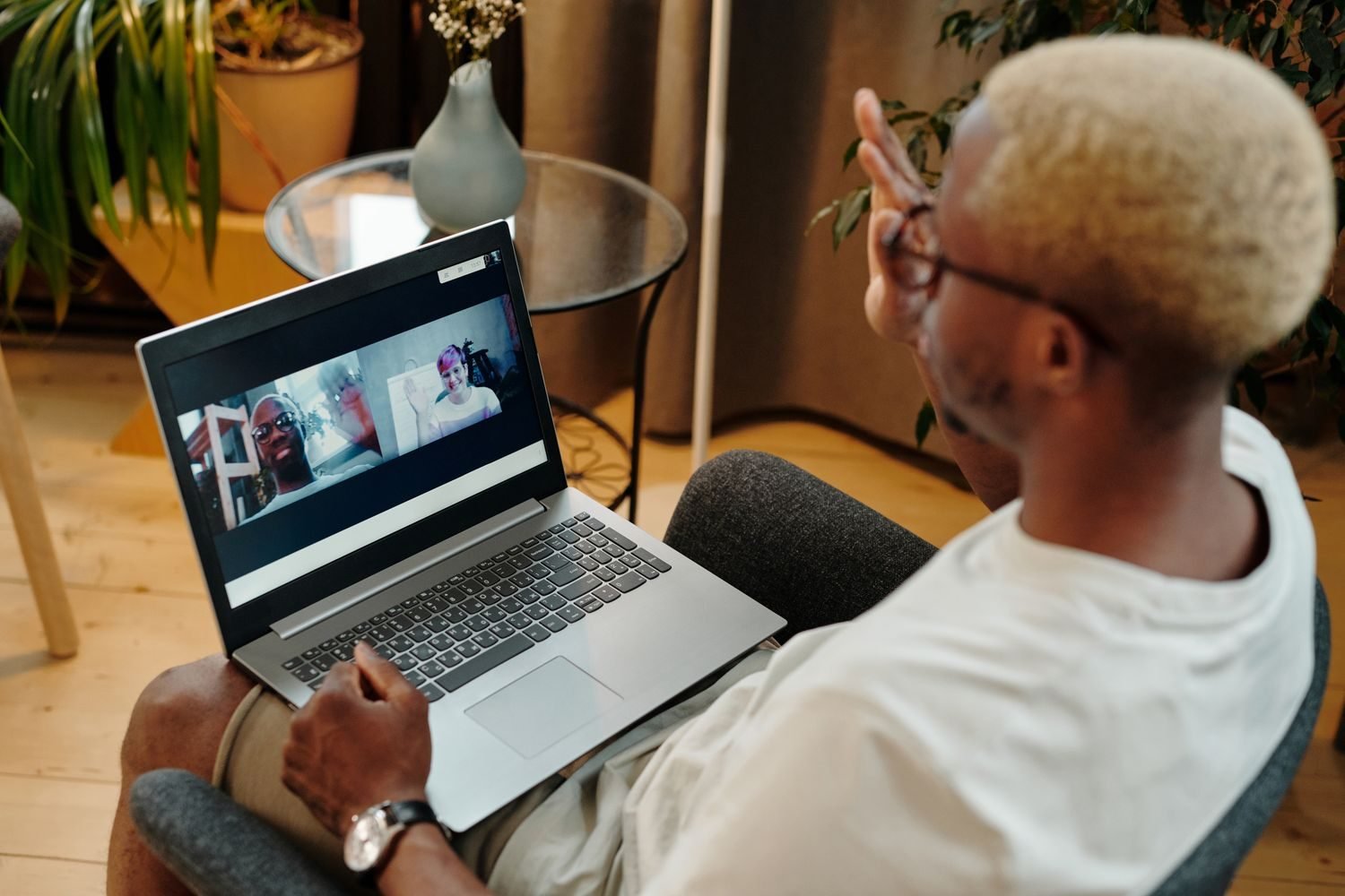 Person having a video call with an online nutritionist from home, laptop showing a diet plan