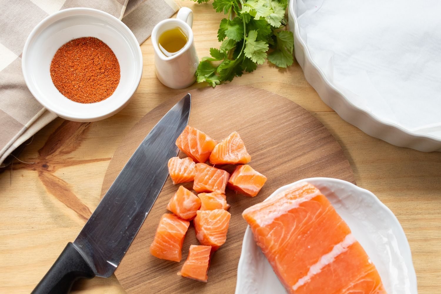 Assortment of heart-healthy foods including salmon, leafy greens, walnuts, olive oil, and berries arranged on a table