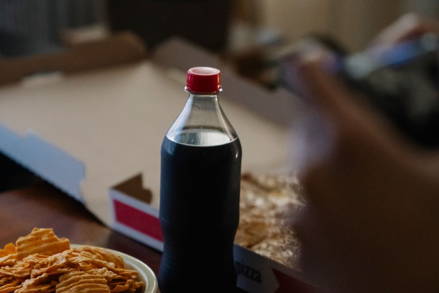 Comparison of unhealthy processed foods including bacon, canned soup, chips, and sugary soda linked to heart disease risk