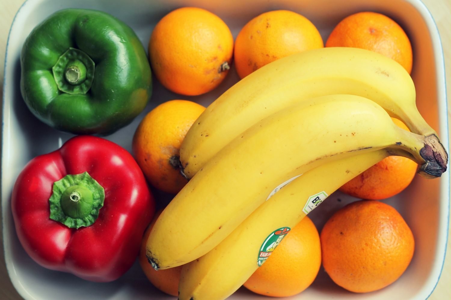 Fresh bell peppers, citrus fruit, and broccoli arranged together as vitamin C sources linked to cortisol regulation