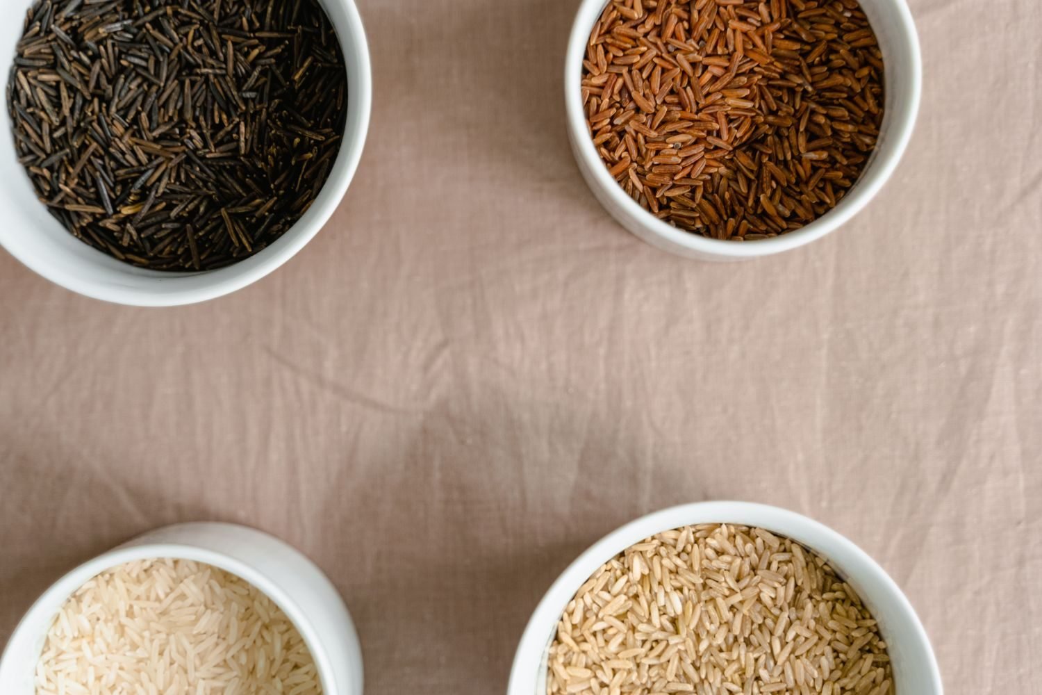 Bowls of almond flour, coconut flour, rice flour, besan, ragi flour, and jowar flour arranged for comparison