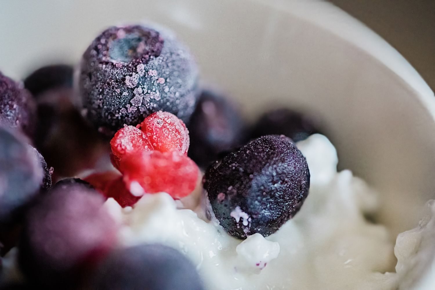 Homemade fruit and yogurt smoothie next to whole milk and fresh fruit as toddler-friendly nutrition options