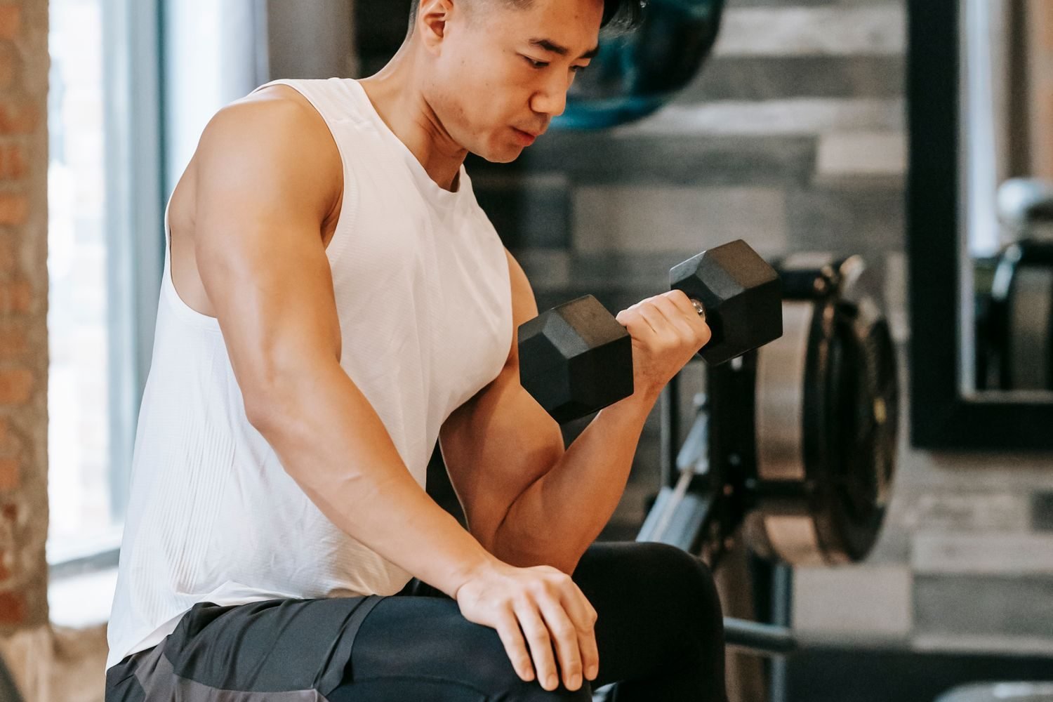 Close-up of a bicep curl with a dumbbell during a gym workout