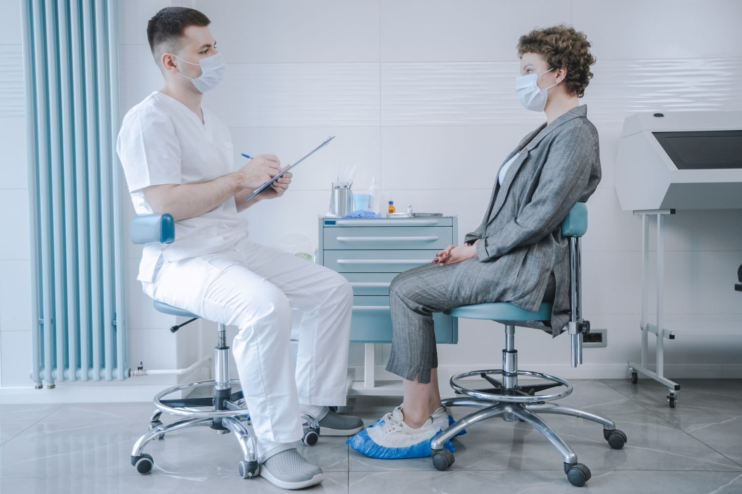 Person having a supportive conversation with a doctor or therapist in a calm clinical setting