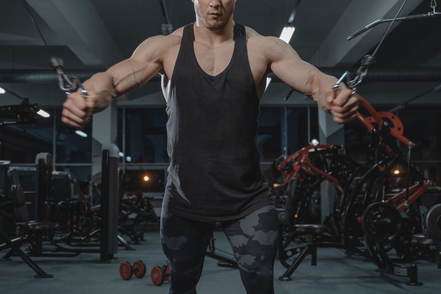 Close-up of a man performing a cable crossover exercise for the chest