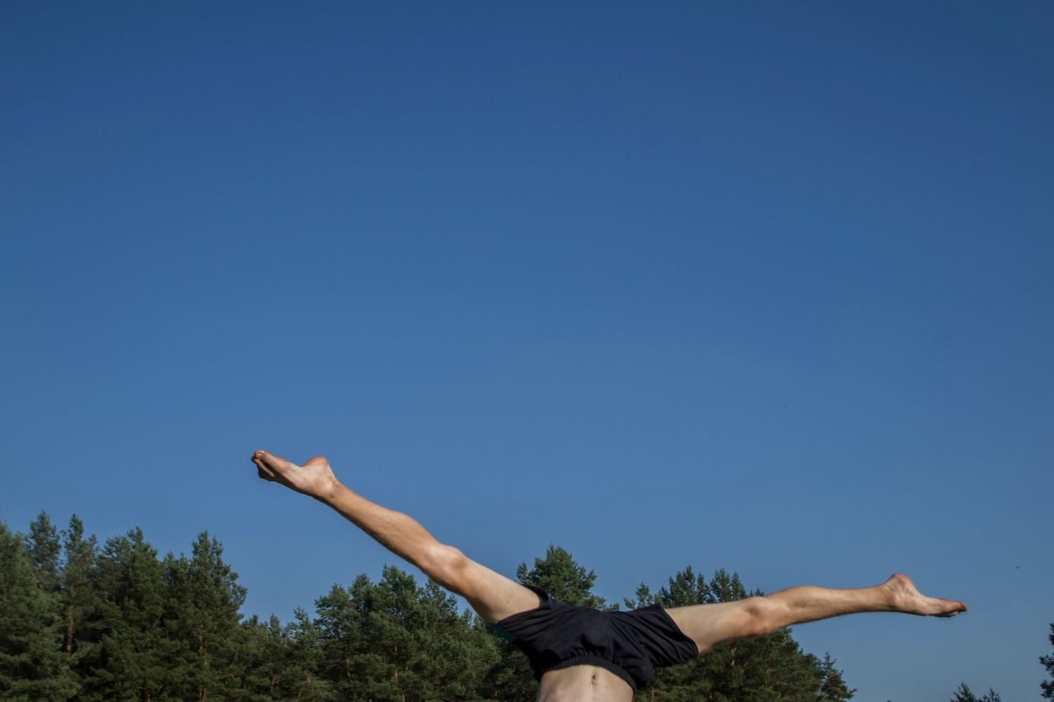 Man practicing a handstand outdoors