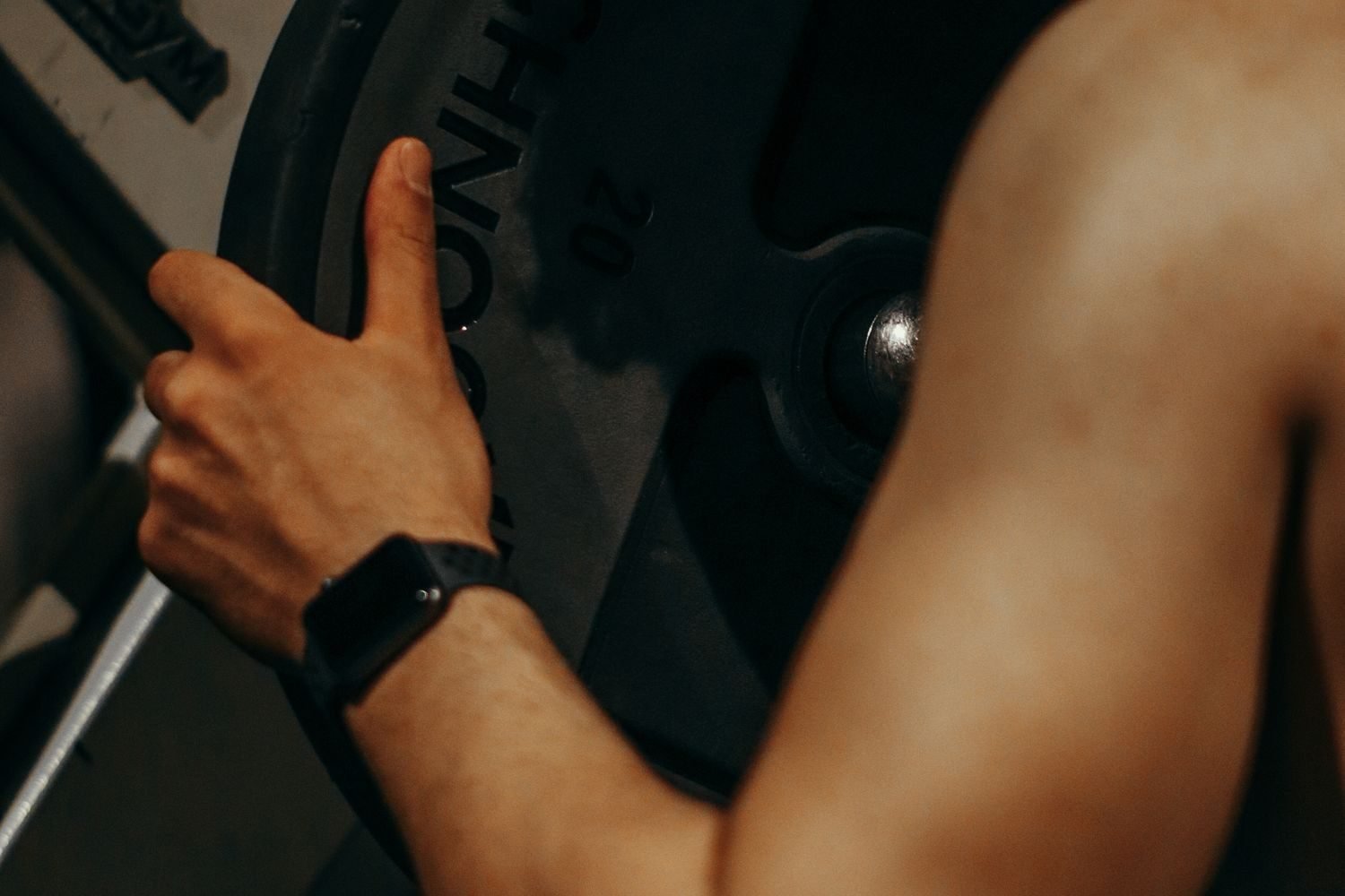 Person tracking a muscle-gain plateau with a food log and strength training progress chart