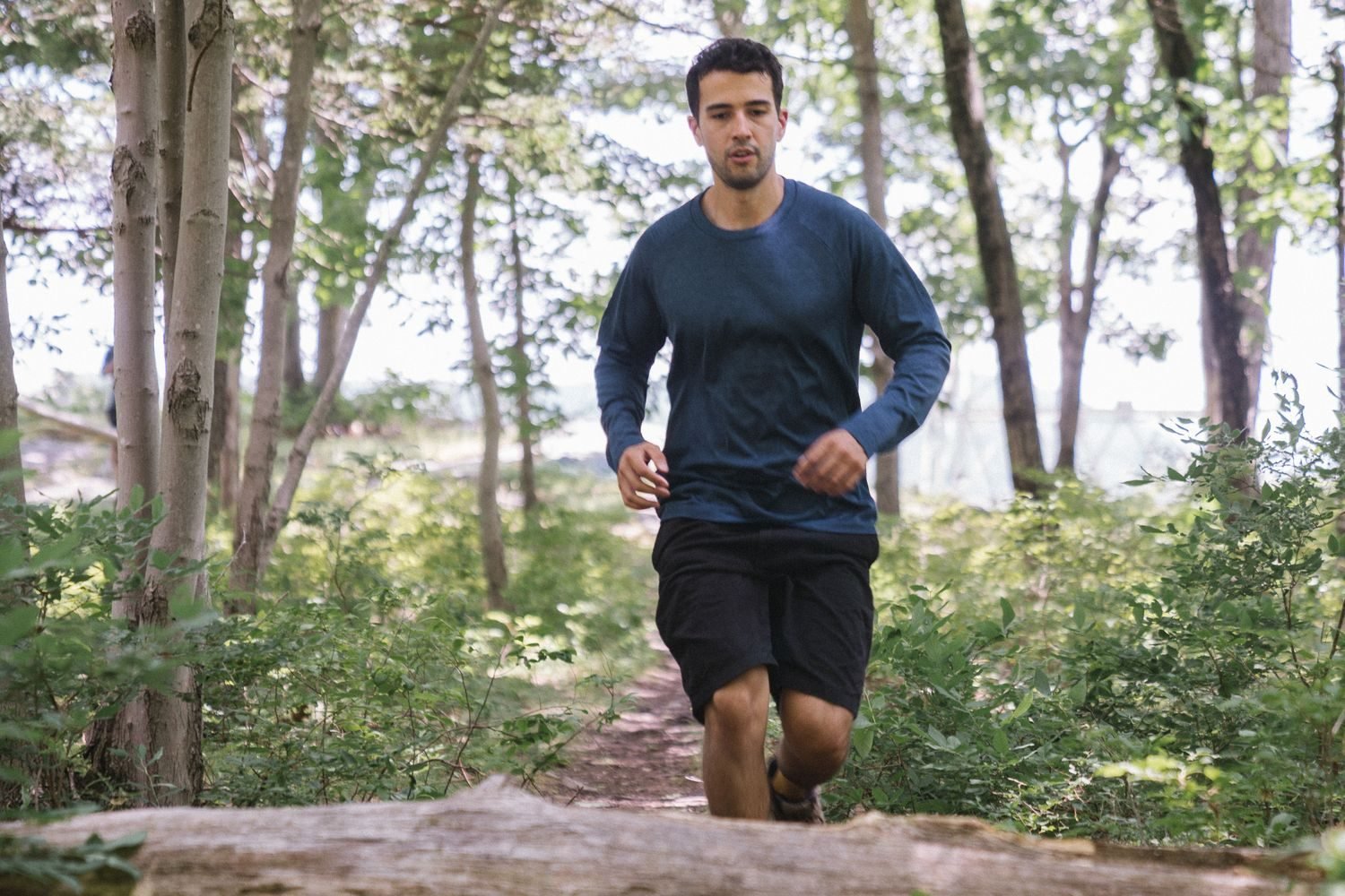 Man running on an outdoor trail during a cardio workout