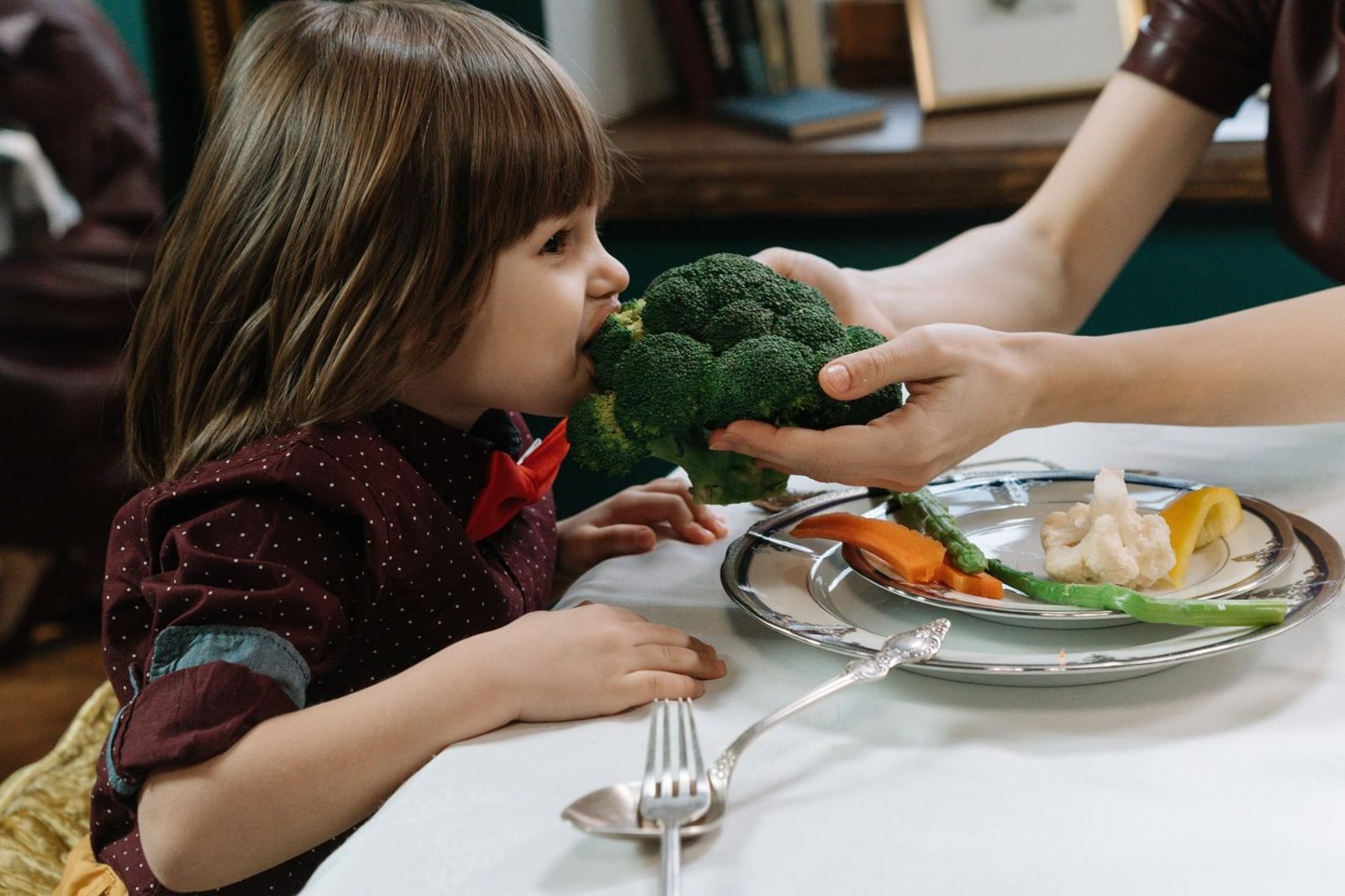 Colorful plate of fruits, vegetables, and protein foods that support a child's immune system