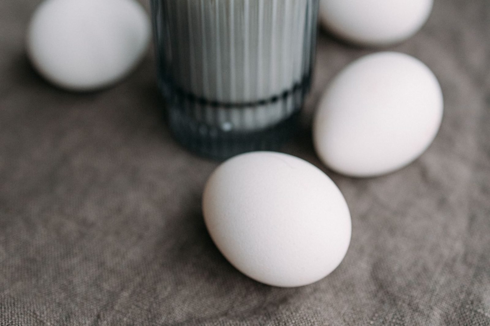 Child drinking a glass of milk alongside a plate of eggs and whole grain toast
