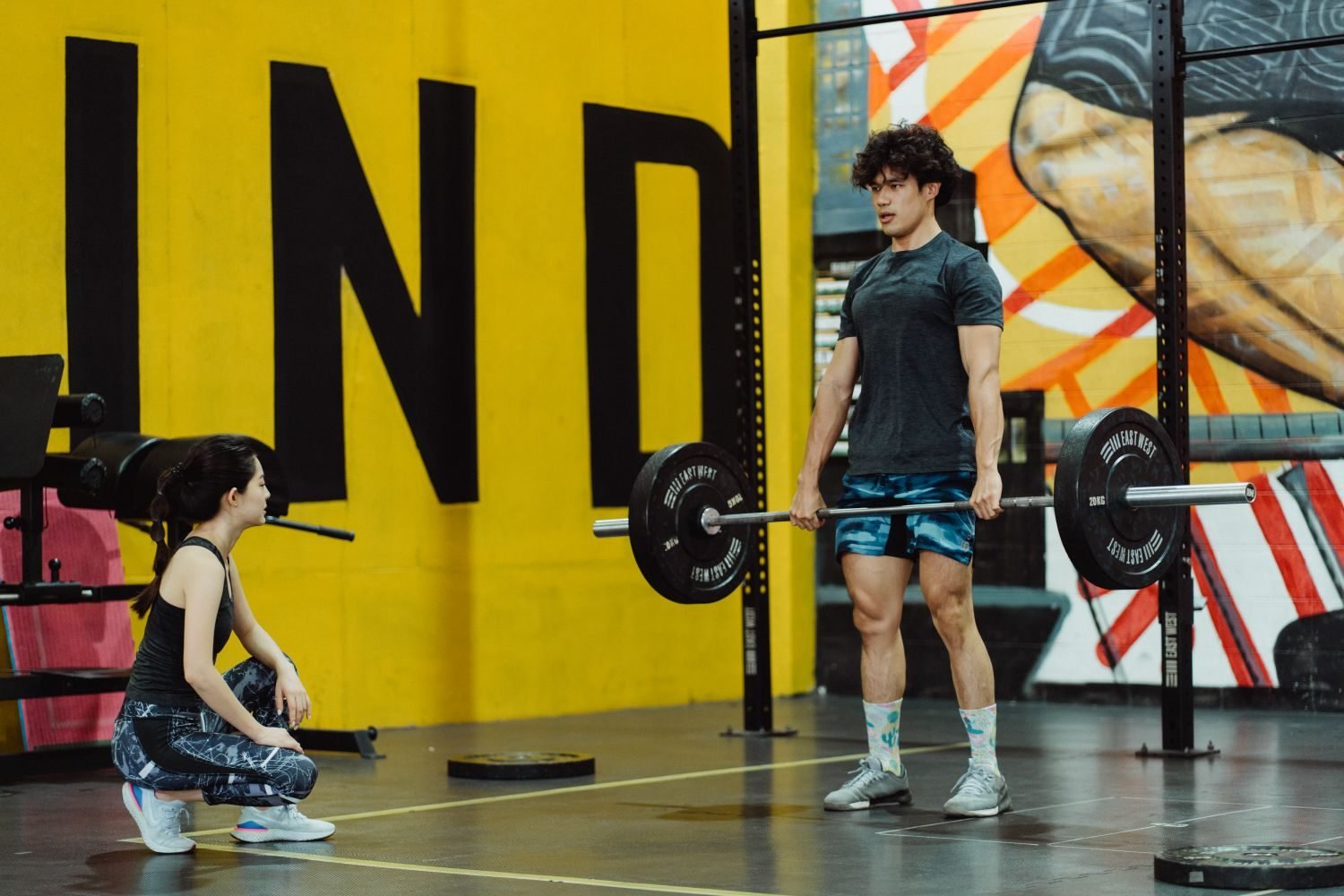 Man performing a barbell deadlift in the gym