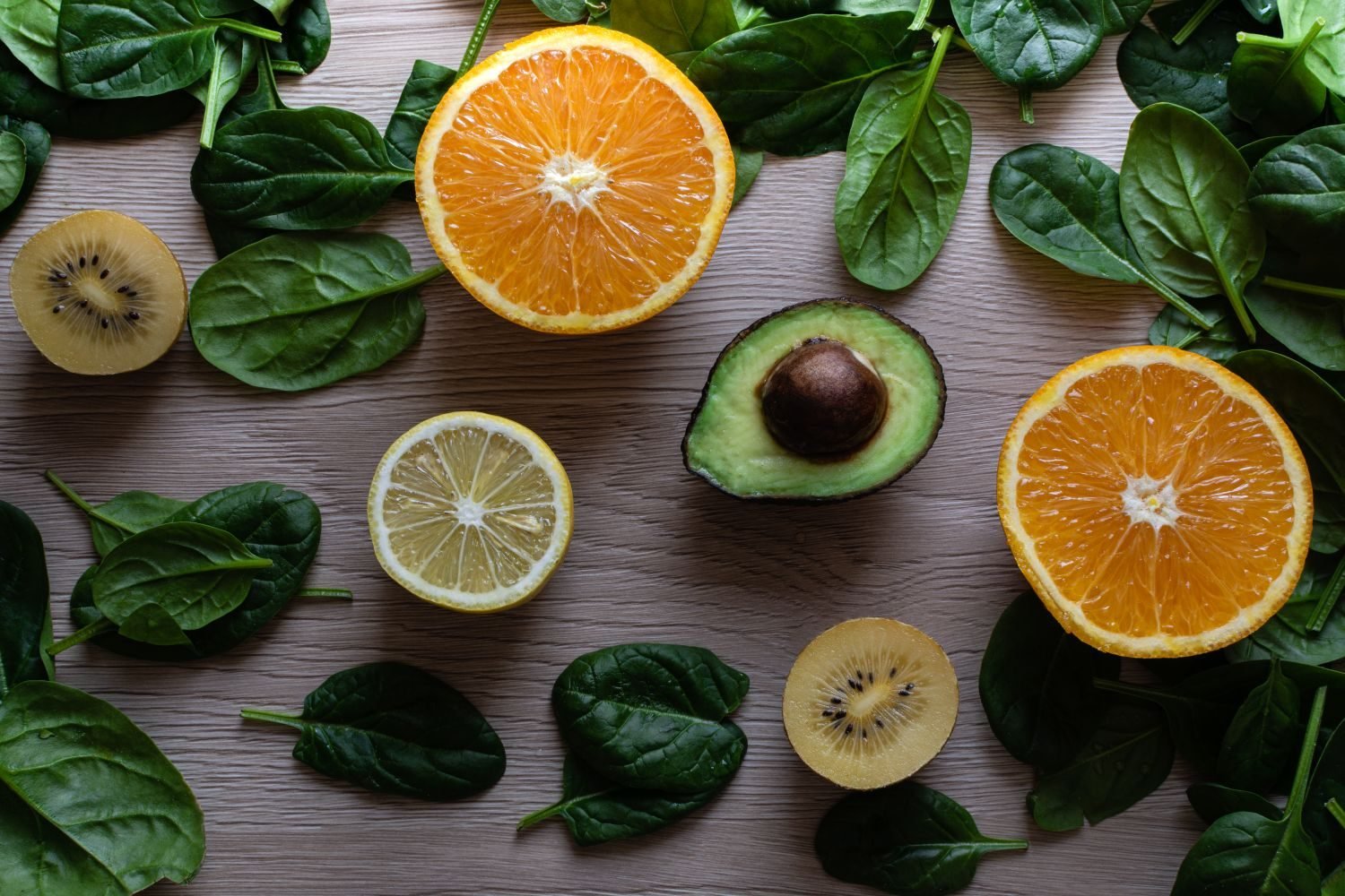 Iron-rich foods for women including spinach, lentils, red meat and citrus fruit to support absorption