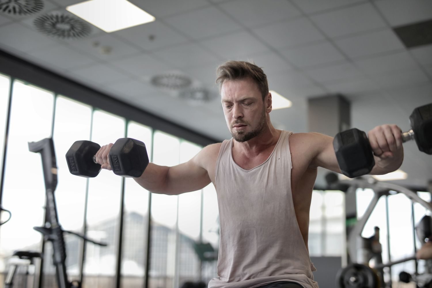 Man performing a dumbbell lateral raise for shoulder training