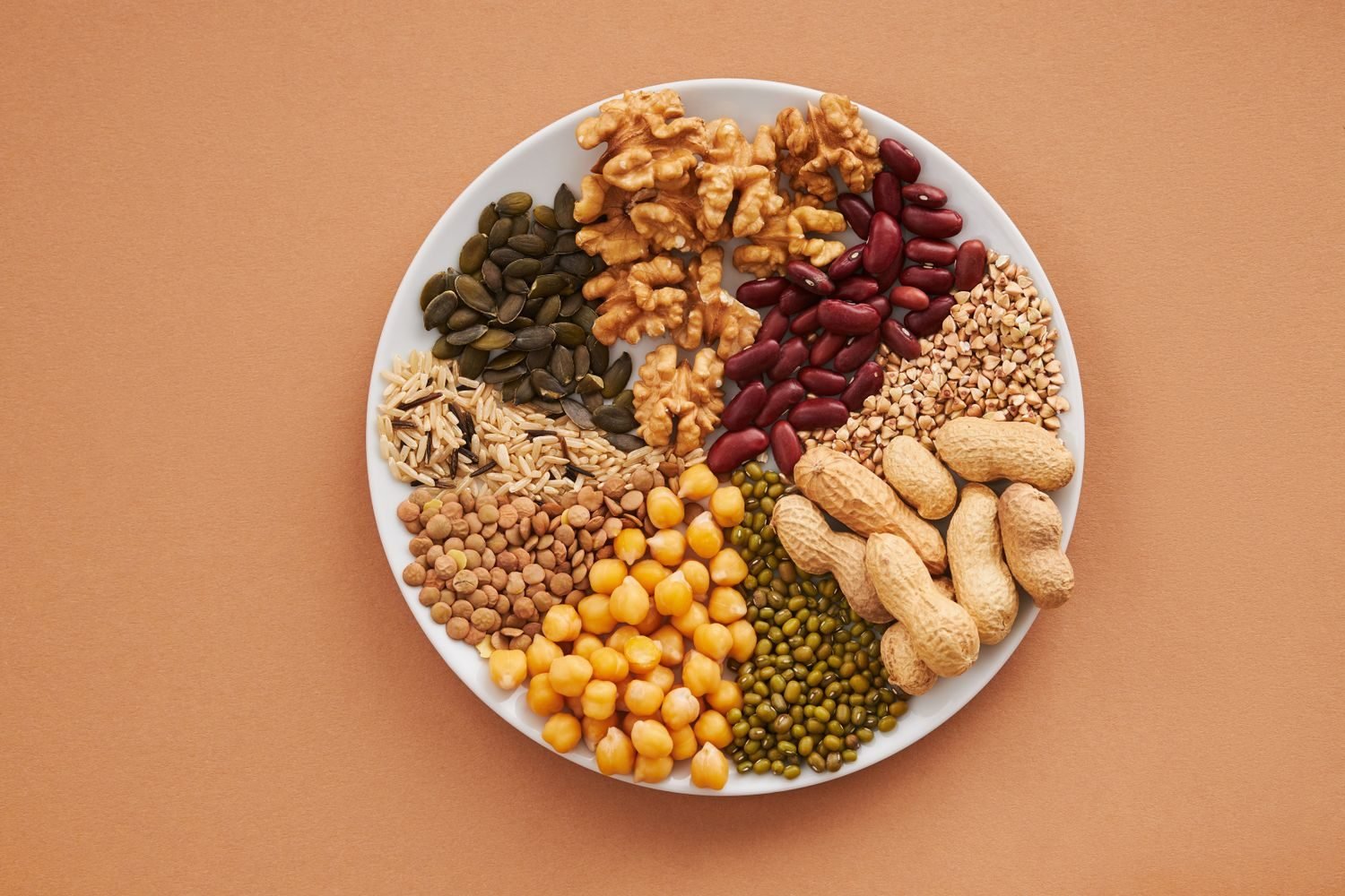 Plate showing balanced portions of whole grains, legumes, vegetables and healthy fats for heart health
