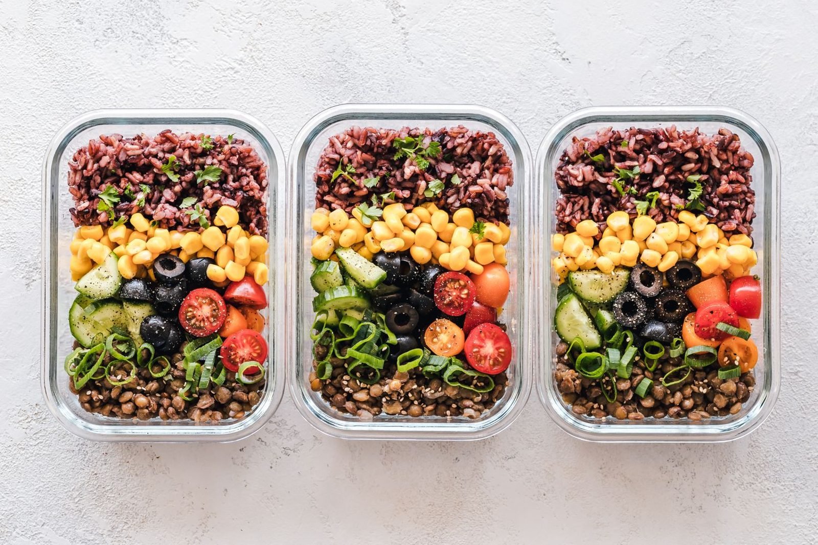 Person meal prepping a variety of colorful whole foods to support balanced nutrition