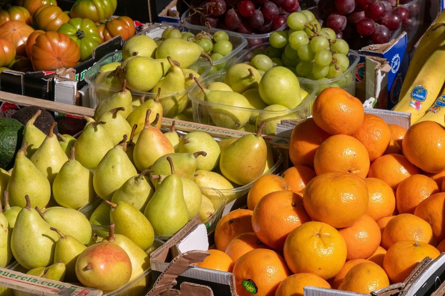 Assortment of nutrient-dense whole foods including leafy greens, citrus fruit, eggs, and fatty fish that help prevent deficiency diseases