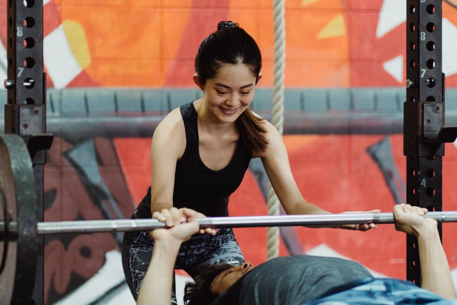 Personal trainer spotting a client on a bench press