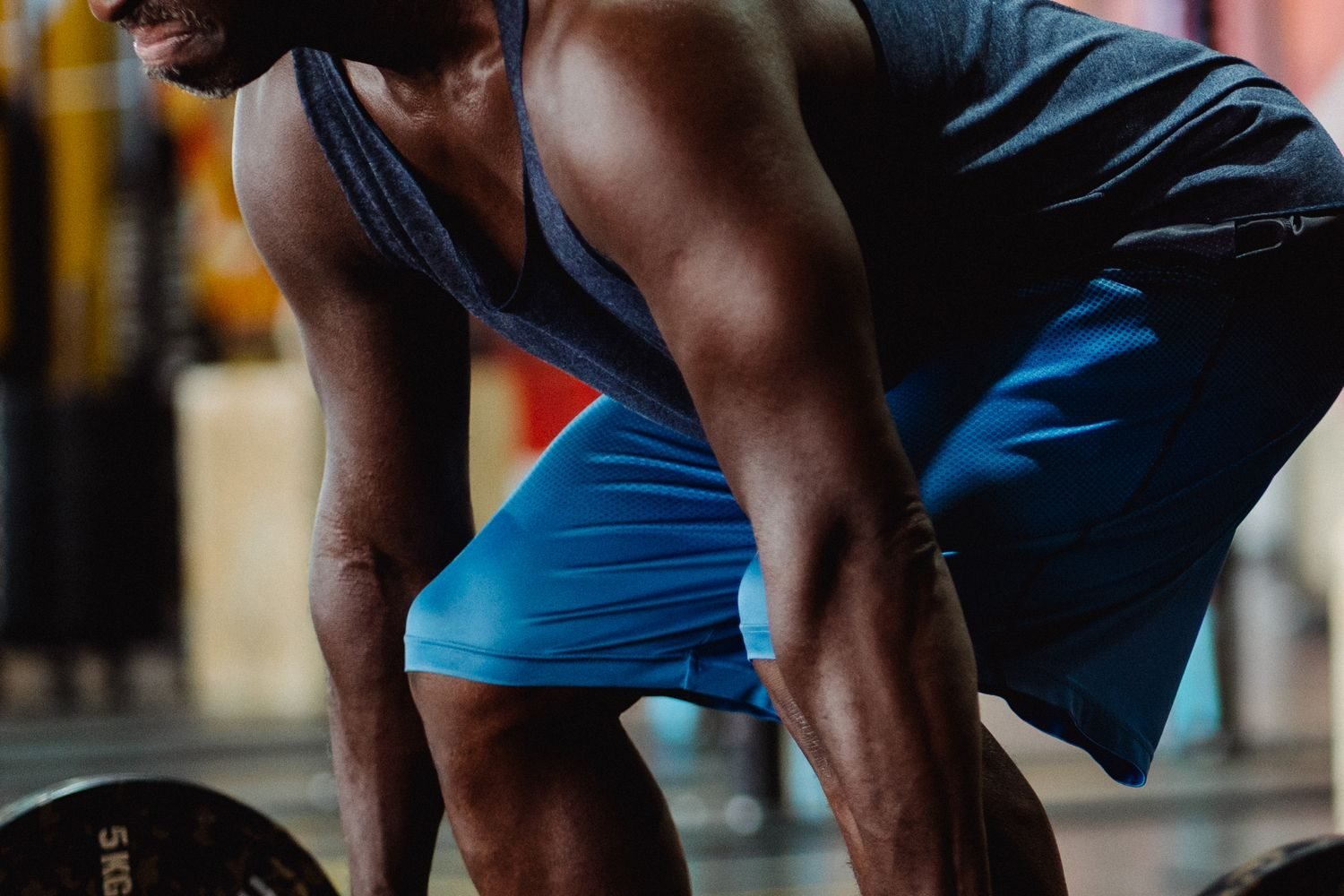 Man setting up for a barbell deadlift in the gym