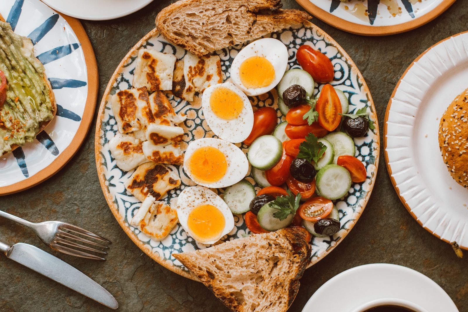 Plate of boiled eggs served with toast and vegetables for a pre-workout breakfast