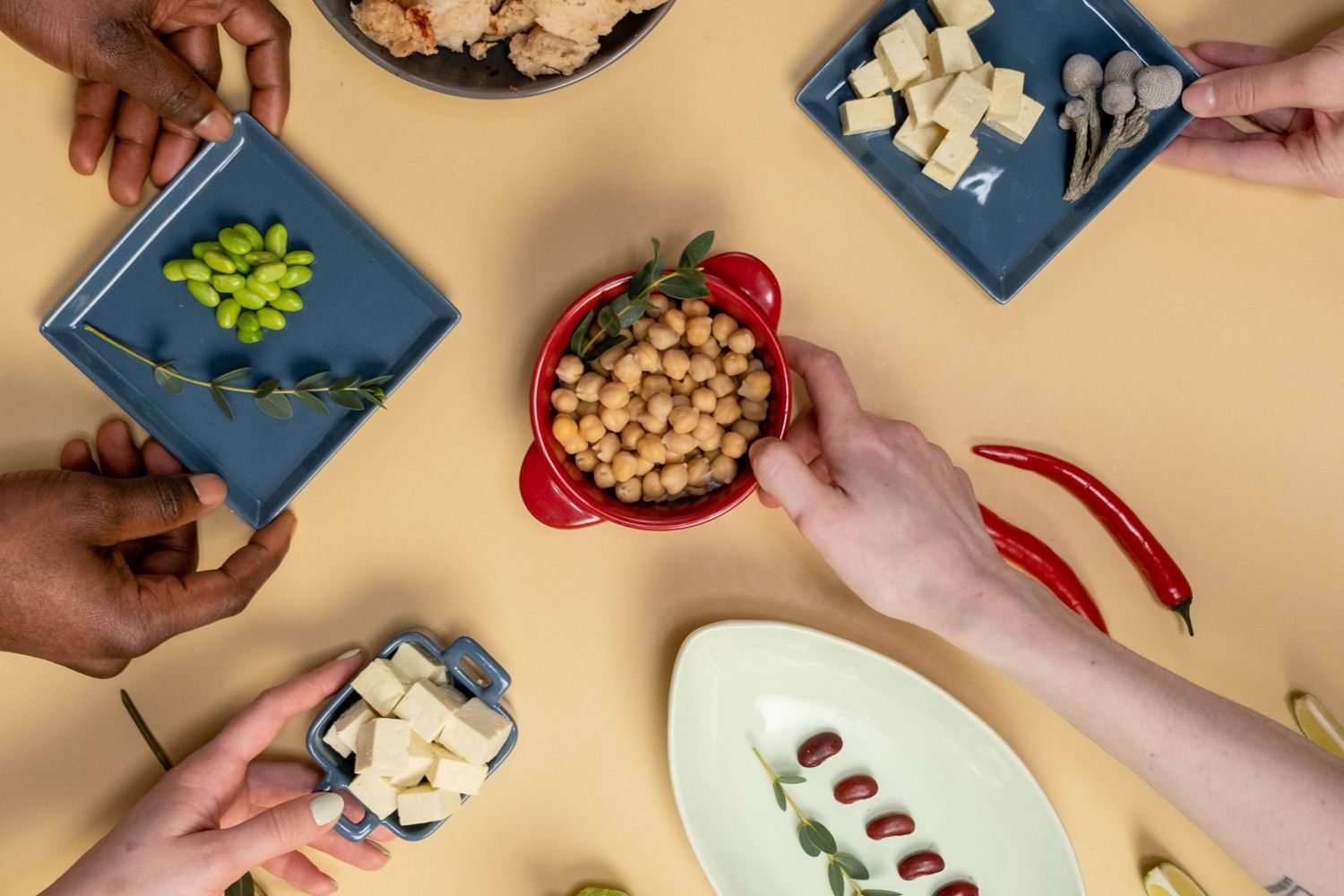 Assortment of phytoestrogen-rich foods including soybeans, edamame, flaxseeds, and chickpeas arranged on a wooden table