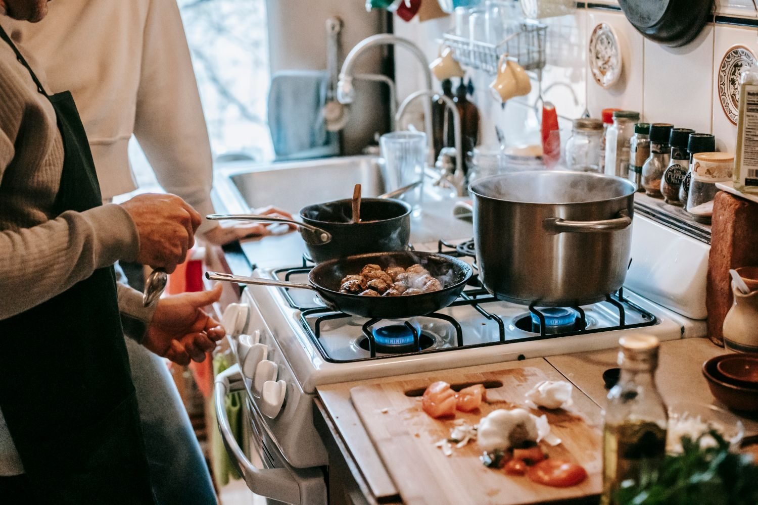 Couple preparing a Mediterranean-style meal with vegetables, olive oil, and whole grains for fertility nutrition