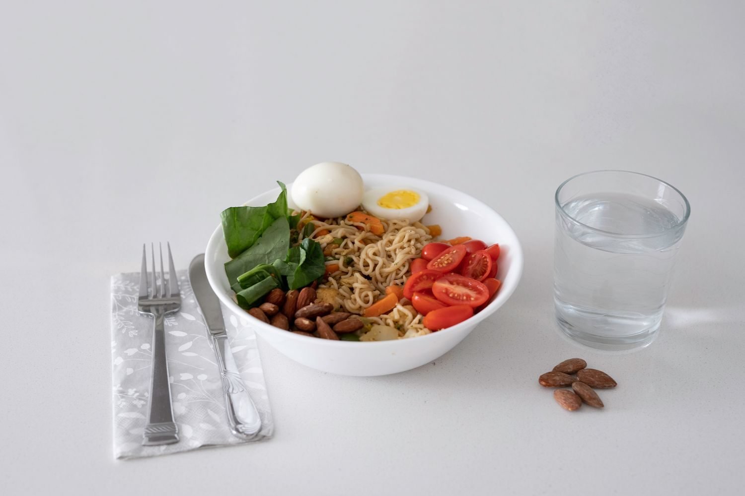 Assortment of sleep-supporting foods including almonds, tart cherries, spinach, and pumpkin seeds arranged on a wooden table