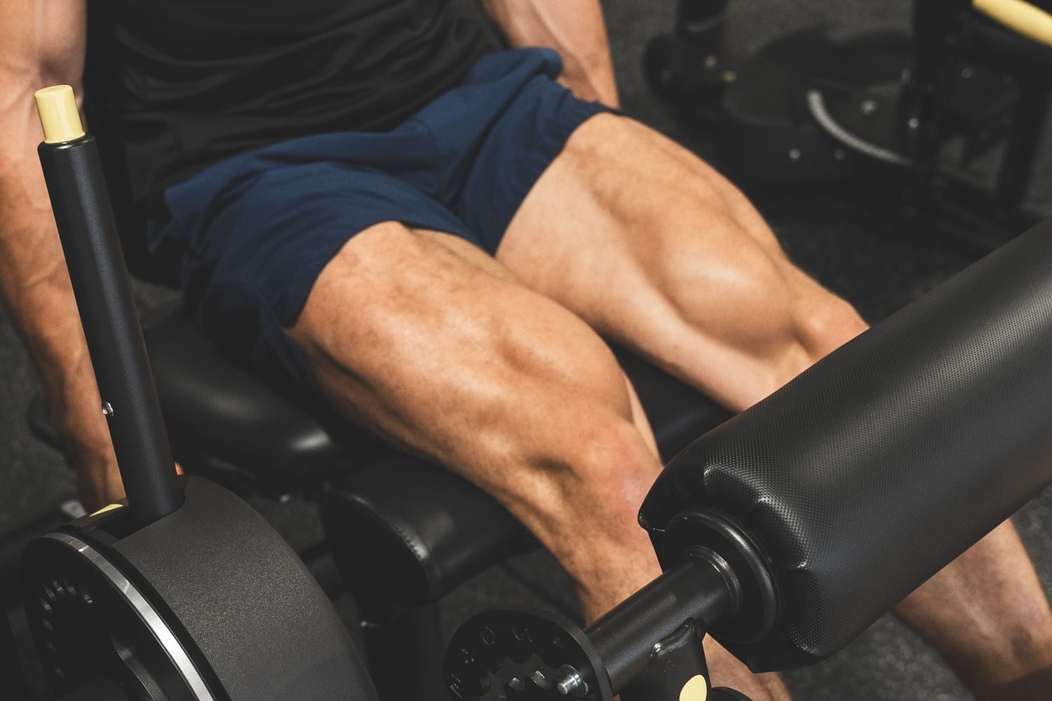 Close-up of a man's legs during a gym leg workout