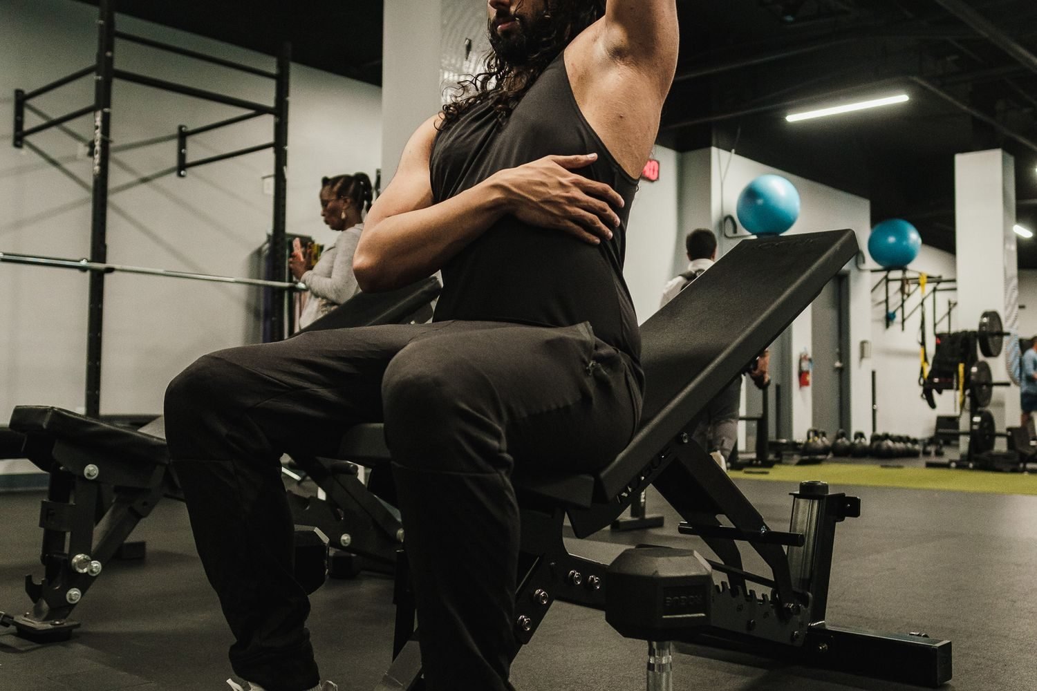 Man performing an overhead dumbbell shoulder press