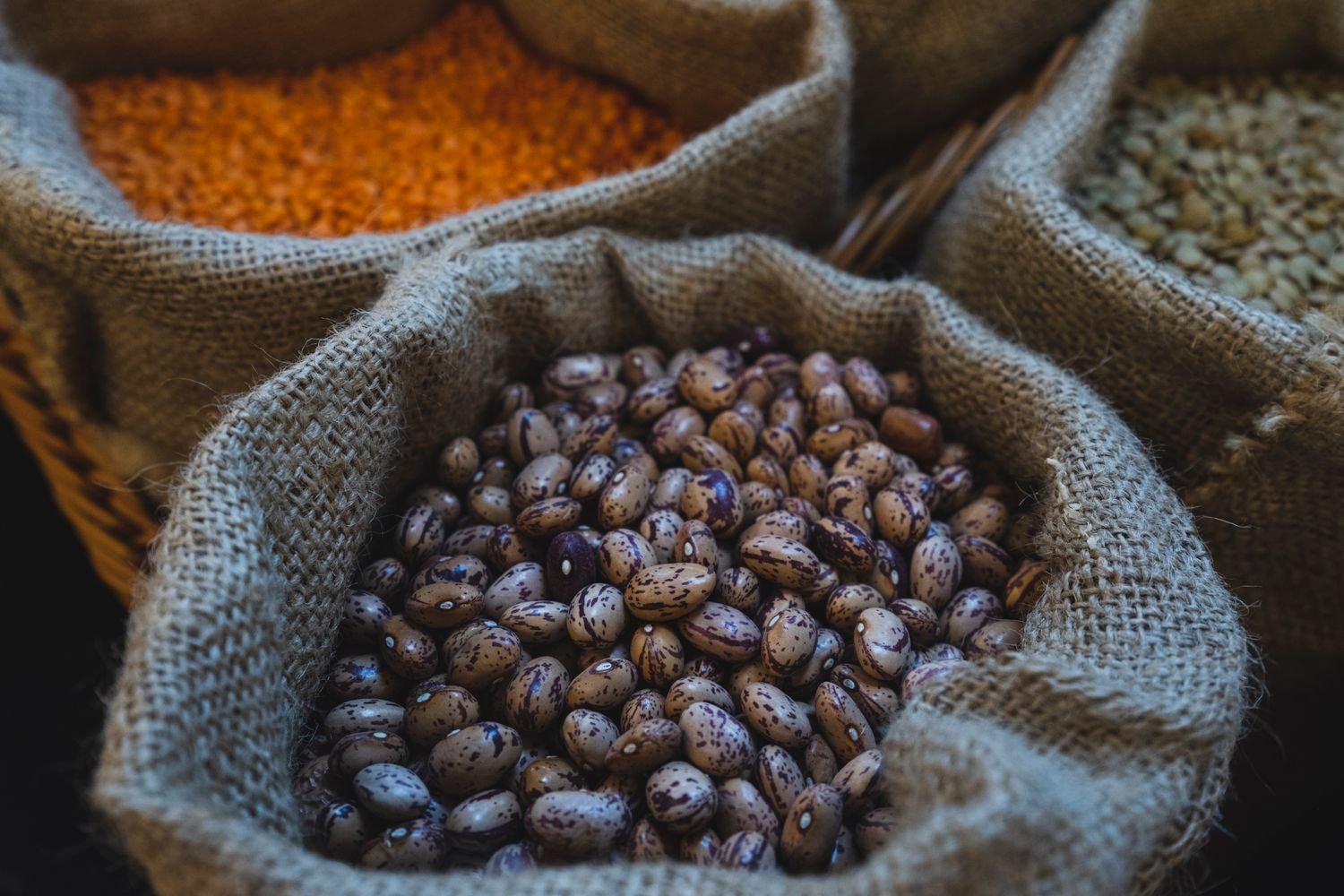 Fresh high-fiber foods including vegetables, legumes, and whole grains on a table