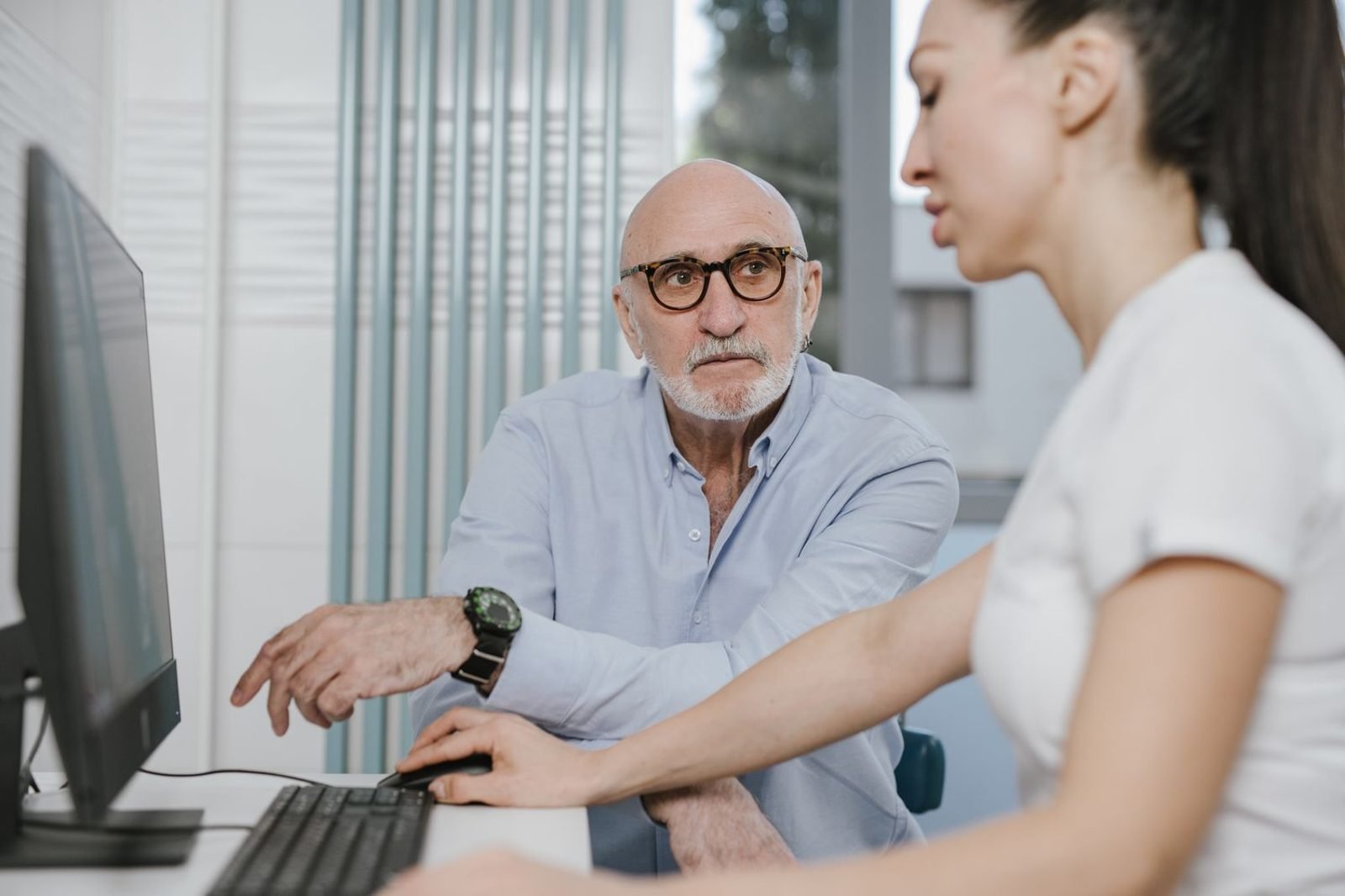 Doctor reviewing bloodwork results for vitamin B12 and vitamin D levels with an elderly patient
