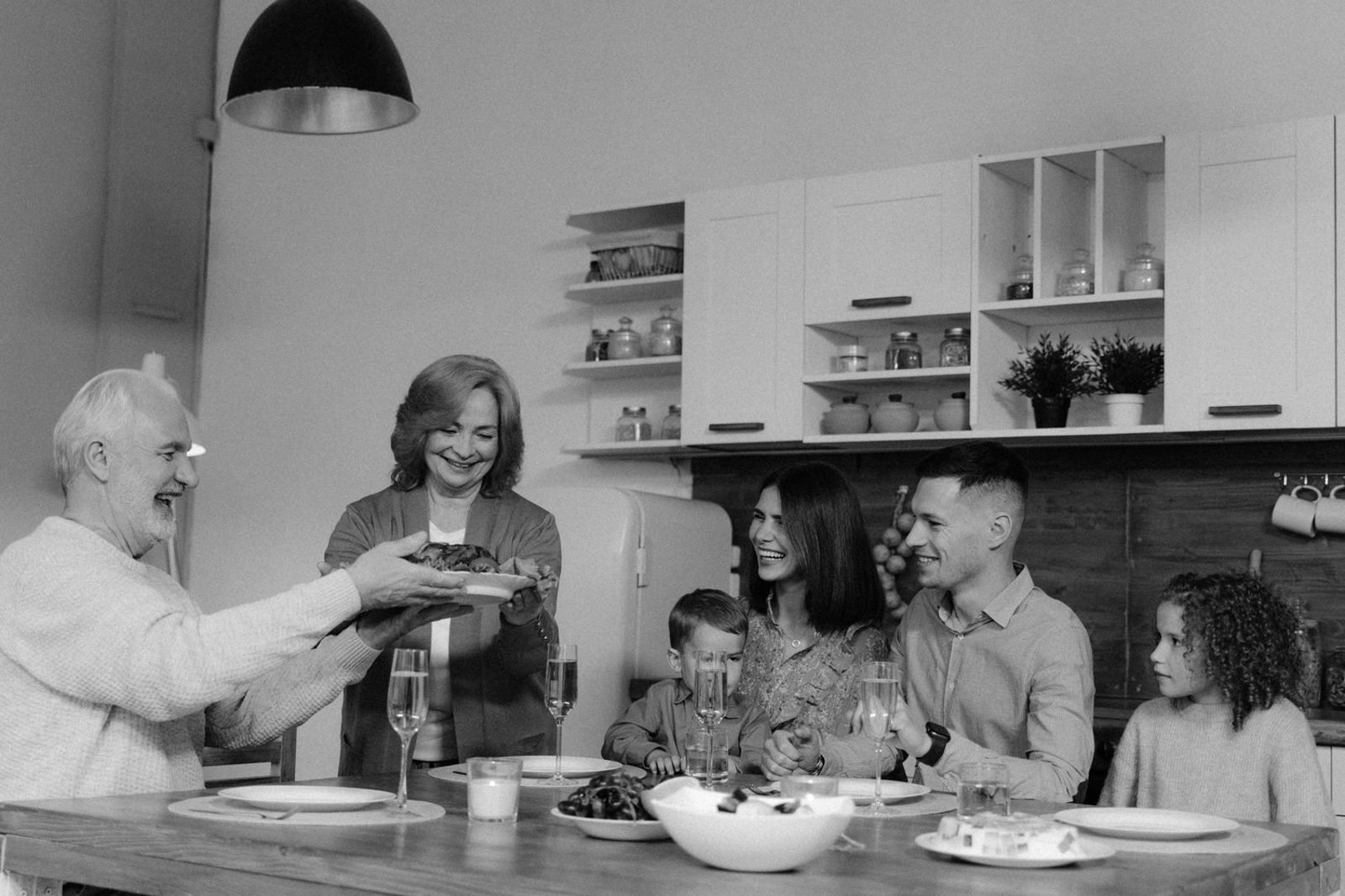 Family sharing a nutrient-dense meal together with an elderly grandparent at the table