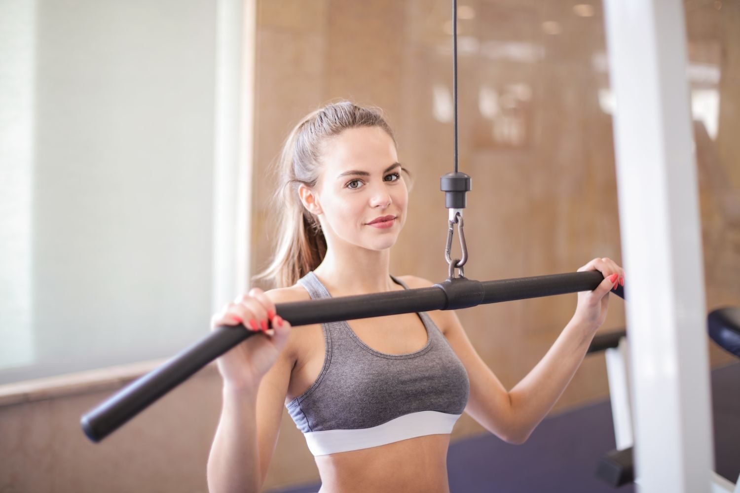 Woman performing a cable machine exercise at the gym