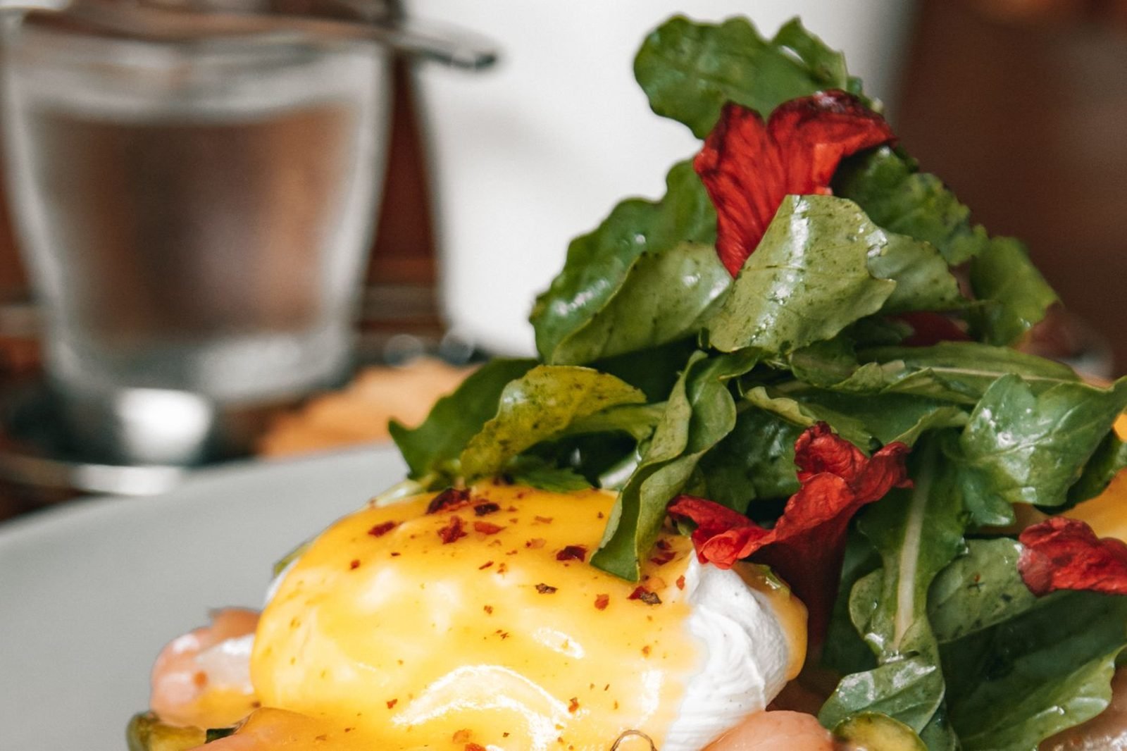 Plate of iron-rich and protein-rich foods for hair growth including eggs, spinach, lentils and salmon