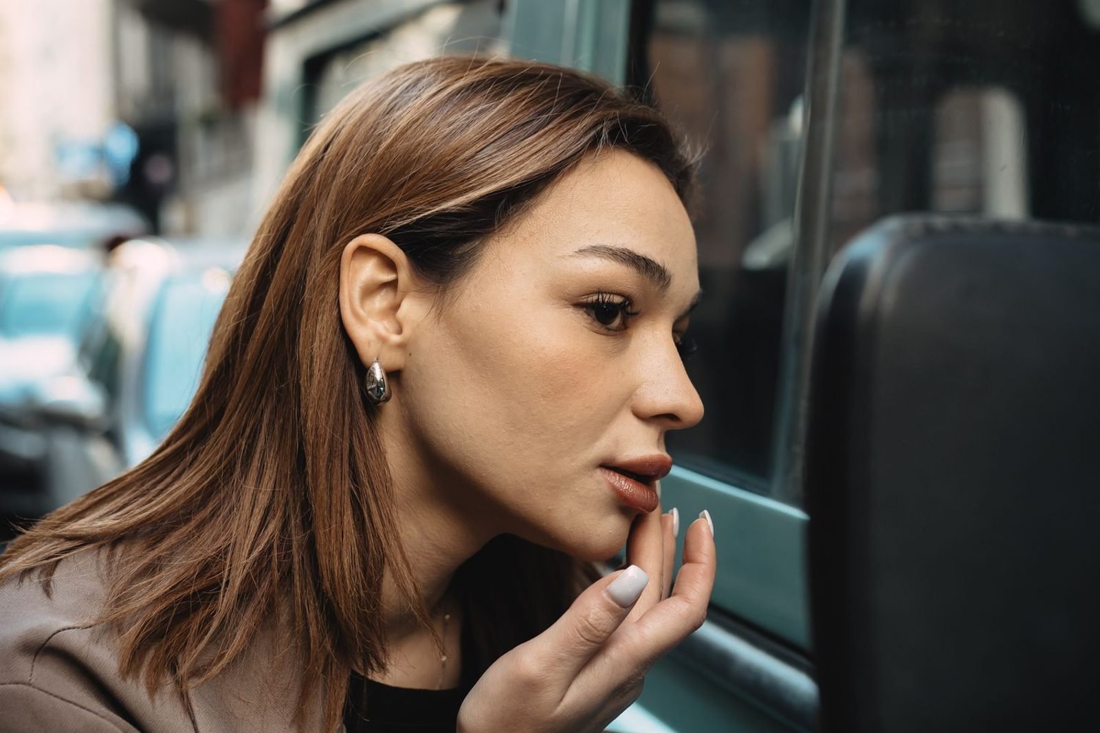 Woman checking hair thinning at the part line, illustrating signs of nutrition-related hair regrowth needs
