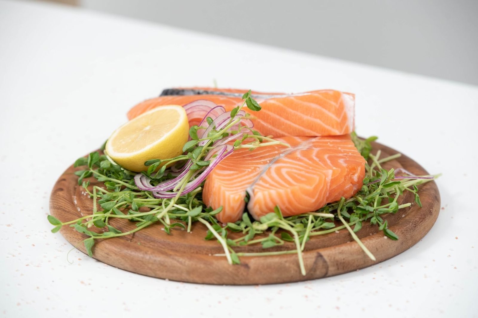 Plate of hair-healthy foods including eggs, salmon, pumpkin seeds, and leafy greens