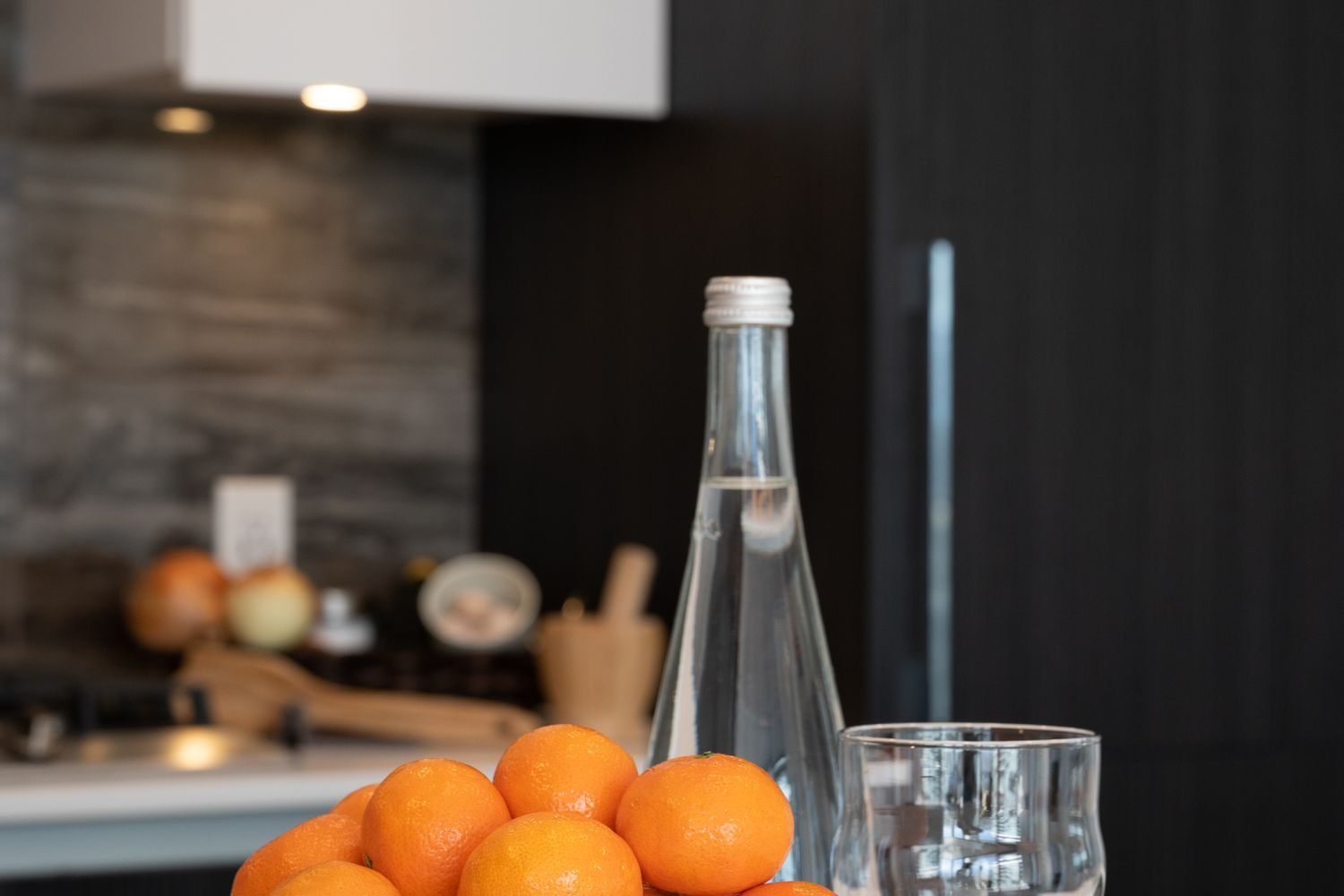 Kitchen counter set up with a visible water bottle and fruit bowl to support easy healthy habits