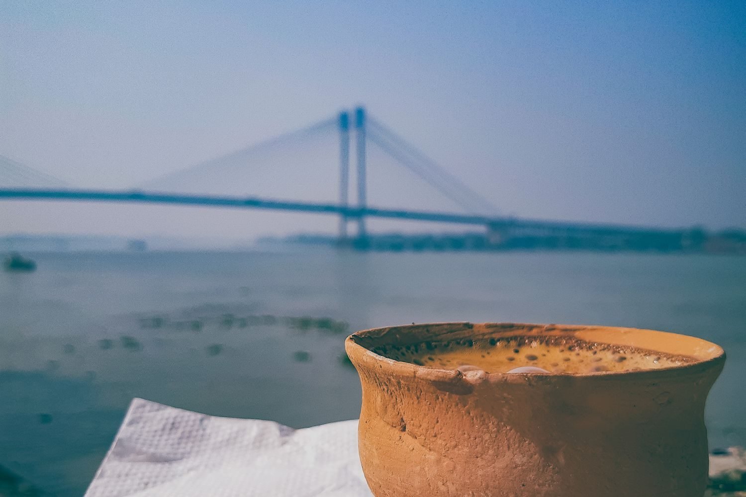 Bowl of roasted makhana and masala chai on a wooden table for evening snack time