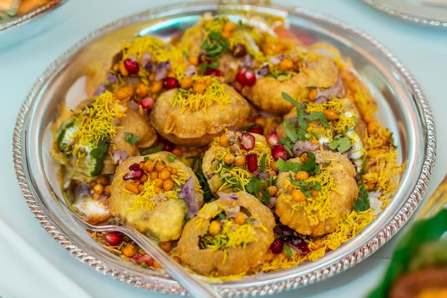 Sprouts bhel with pomegranate and coriander served as a healthy Indian evening snack